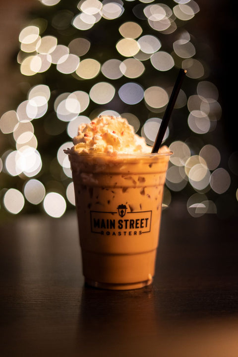 Iced Coffee Drink in Main Street Roasters cup with whipped topping