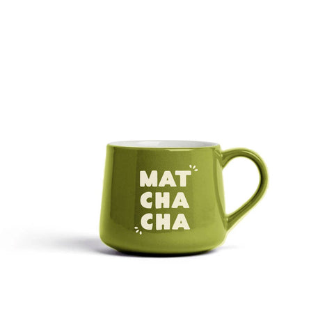 A green ceramic coffee mug with the words 'MAT CHA CHA' printed in white on the front, set against a plain white background.
