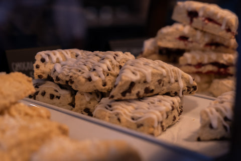 Stacks of scones with a glaze on a tray, blurred background