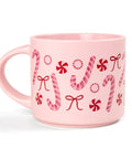 Pink mug with candy cane and bow pattern on a white background