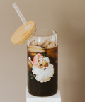 Glass of iced coffee with a Santa Claus design on a beige background