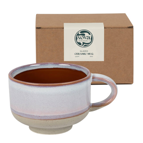 Ceramic mug with brown interior and beige exterior in front of a Nova Ceramics box.