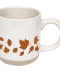 White mug with brown leaf patterns on a white background