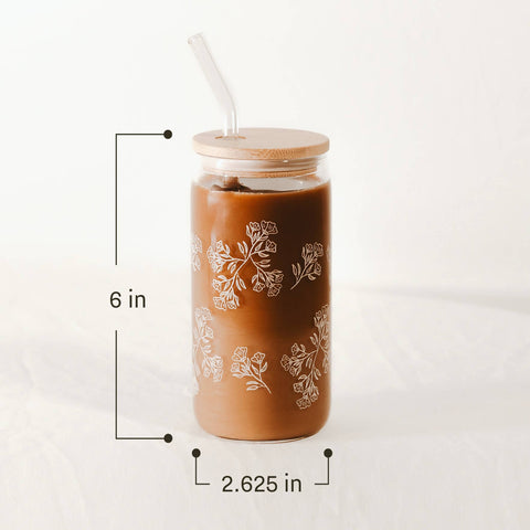 Brown tumbler with floral patterns and straw on a white background with dimensions