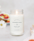 Strawberry Mango candle in a glass jar with a blurred background