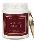 Candle in a jar with 'Autumn Orchard' label on a white background