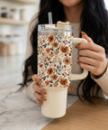 Person holding a floral-patterned tumbler in a kitchen setting