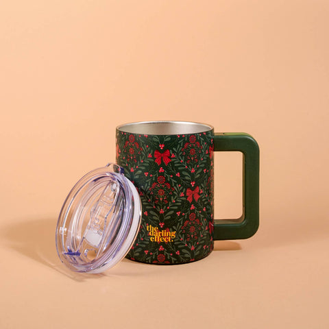 Floral-patterned mug with a clear lid on a beige background