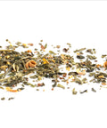 Dry tea leaves scattered on a white background