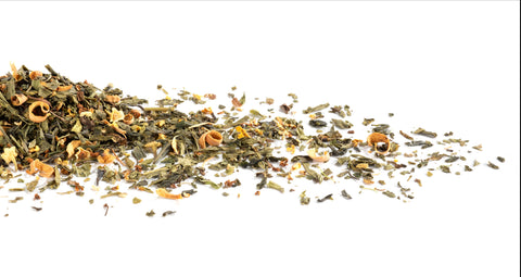 Dry tea leaves scattered on a white background