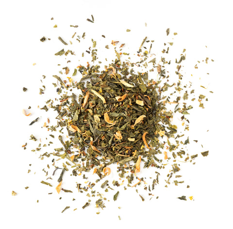 Dry green tea leaves on a white background