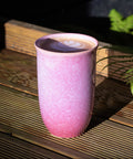 Purple ceramic mug on a wooden surface