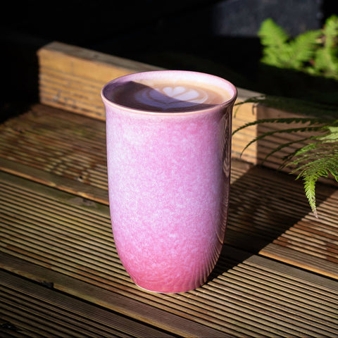 Purple ceramic mug on a wooden surface