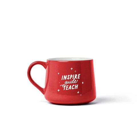 A red ceramic coffee mug with the words 'INSPIRE guide TEACH' in white script and star accents, shown on a clean white background.