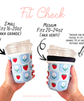 Two hands holding fabric coffee cup cozies with text indicating size compatibility.