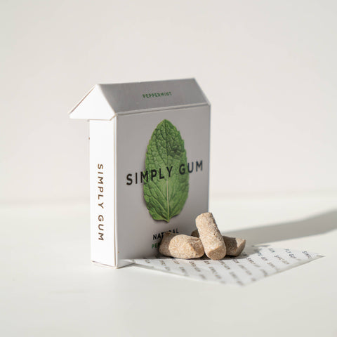 Box of Simply Gum with two pieces of gum on a white background