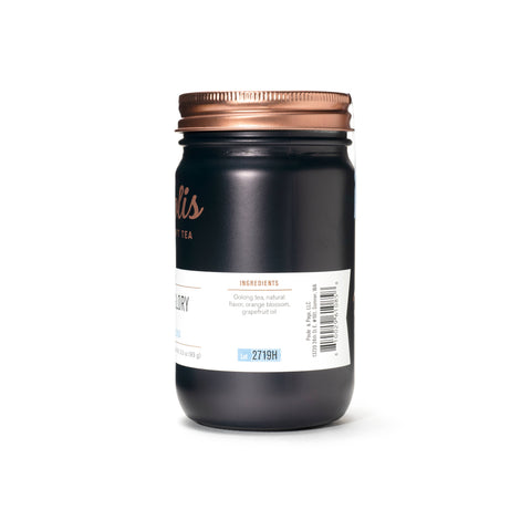 Black jar with a copper lid on a white background