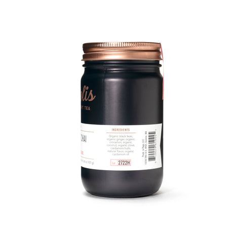 Black jar with a copper lid on a white background