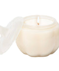 White ceramic container with a lid and a candle inside on a white background
