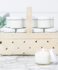 Antique Candle Co.® - Wicker basket filled with white jar candles on a marble surface - Main Street Roasters®
