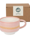 Pink ceramic mug with gold accent in front of a brown box labeled 'Nova Ceramics'.