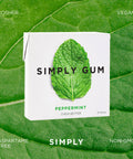 Simply Gum packaging on a green leaf background
