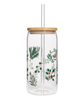 Clear glass jar with wooden lid and festive plant design on a white background