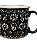 Black mug with white floral pattern on a white background