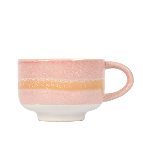 Pink ceramic mug with a yellow stripe on a white background