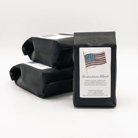Black coffee bag labeled 'Americana Blend' with an American flag on a white background