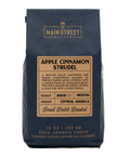 A 10 oz bag of Main Street Roasters Apple Cinnamon Strudel coffee, featuring a dark navy blue bag with a tan label on a white background.