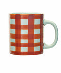 A ceramic mug featuring a red and orange gingham checkered pattern with a light mint green handle and interior, shown against a plain white background.