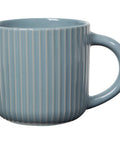 Blue ceramic mug with vertical stripes on a white background