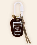 Charm with coffee cup design on a beige background
