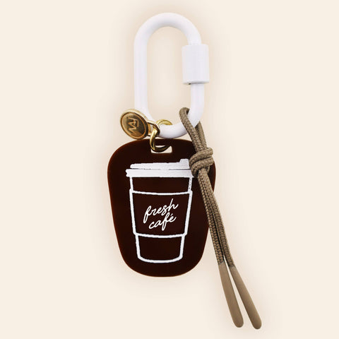 Charm with coffee cup design on a beige background