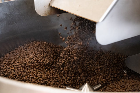 Roasted coffee beans cooling in roaster.