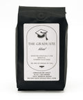 Black coffee bag labeled 'The Graduate' on a white background