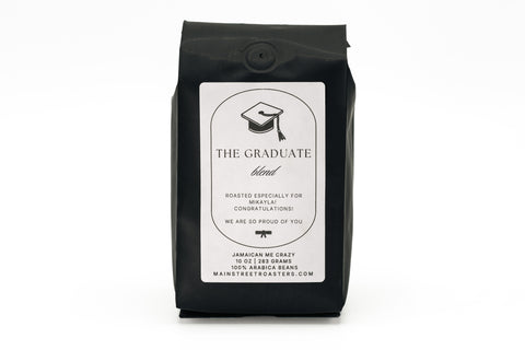 Black coffee bag labeled 'The Graduate' on a white background