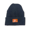 Black knit beanie with a brown leather patch on a white background