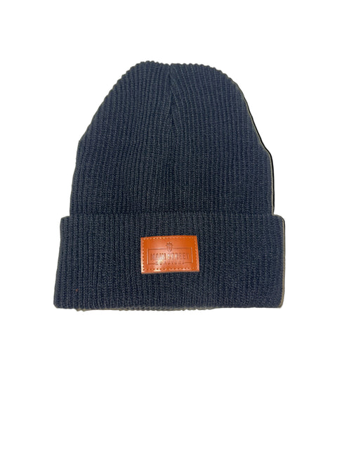 Black knit beanie with a brown leather patch on a white background