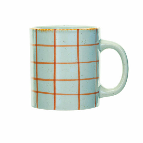 A ceramic mug with a light blue speckled glaze, decorated with a grid pattern of orange lines, and featuring a rustic gold rim, shown against a plain white background.