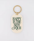Keychain with 'Happy is the New Rich' text on a light background