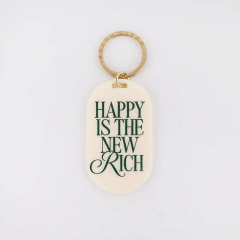 Keychain with 'Happy is the New Rich' text on a light background
