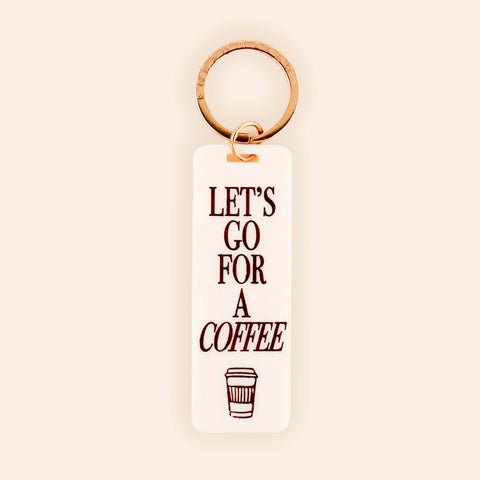 Keychain with 'Let's Go for a Coffee' text on a beige background