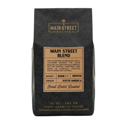 Black coffee bag with 'Main Street Roasters' branding and details about the Main Street Blend.