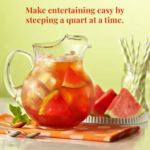 Glass pitcher of watermelon mint with watermelon slices on a polka dot napkin.