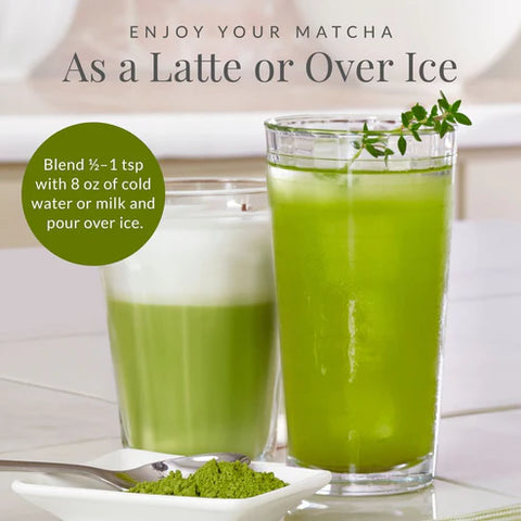 Two glasses of green matcha drink with a spoonful of matcha powder on a white surface.