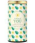Tea canister with floral design and 'thinking of YOU' text on a white background