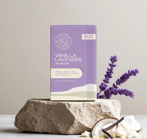 Little Prayer Tea Company Vanilla Lavender tea package on a stone surface with lavender flowers and a vanilla bean.