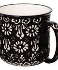 Black mug with white floral pattern on a white background